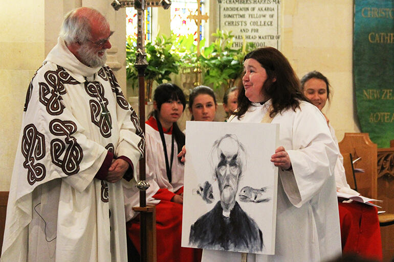 Lynda presents the former Archbishop of Canterbury with a gift following his preaching and presiding at a Christchurch cathedral service last year.