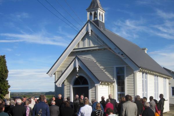 The congregation gathers at the front of Morven Church at the end of its closing service on May 20.