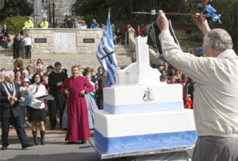 Former mayor Roy McLennan delivers the sword to cut Nelson's birthday cake. Picture: Nelson Mail