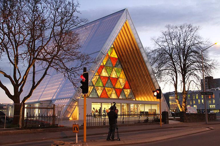Like a celestial tent, the new cathedral glows against the twilight sky. Japanese film crews recorded the opening service. 