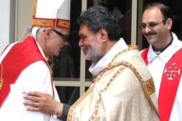 Archdeacon Turi Hollis greets Bishop Jim - and that's their campus colleague Fr George Al-Kopti waiting in the background.