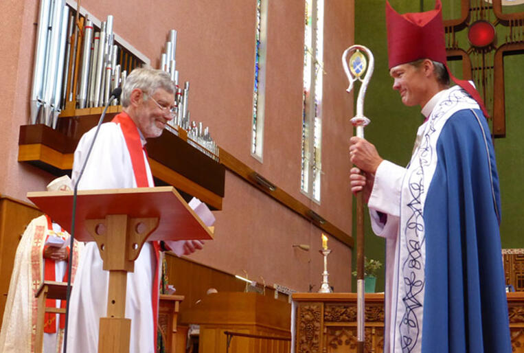 Bishop David Rice hands over his pastoral staff to the Rev Noel Hendery, Waiapu's Deputy Vicar-General.