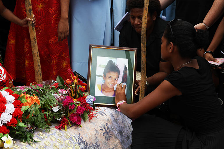 Graveside memories: Silina Rosi, who lives at St Christopher's Home, tenderly cleans the portrait of her lost friend. Graveside memories: Silina Rosi, who lives at St Christopher's Home, tenderly cleans the portrait of her lost friend.