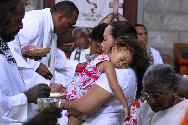 Mum makes her communion - while her daughter is dead to the world, alive to Christ.