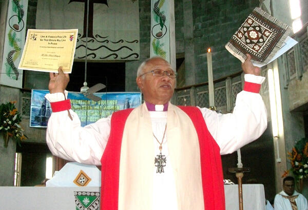 Archbishop Winston Halapua holds aloft the certificates given to all Suva clergy who'd attended the anti-violence workshops.