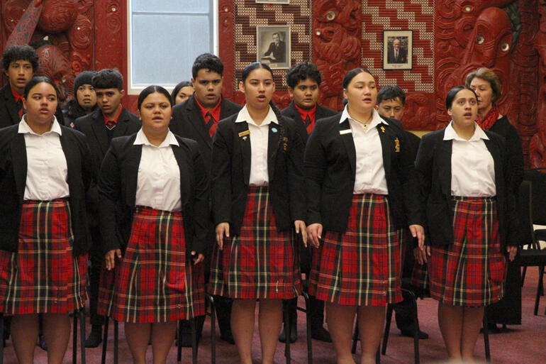 Girls from Hukarere College and boys from Te Aute sing to back the mana whenua speakers. Girls from Hukarere College and boys from Te Aute sing to back the mana whenua speakers.