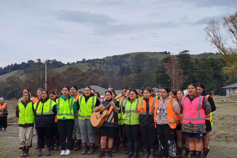 Hukarere girls sing a waiata in the grounds of their flood-ravaged former school and home in Esk Valley.