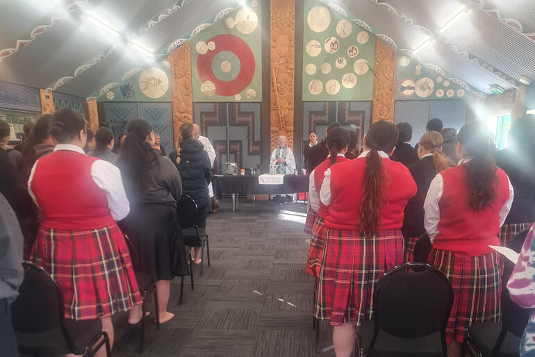 Back together as one body, Hukarere Girls' College join chaplain Rev Erice Fairbrother in communion at Pukemokimoki.