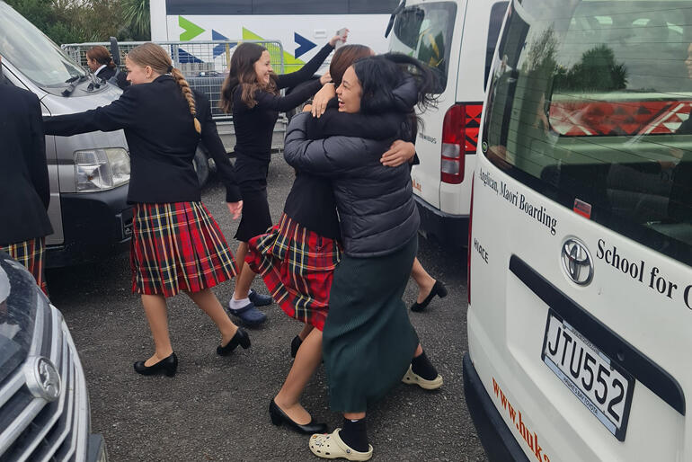 Hukarere pupils can't contain their excitement at seeing each other this May, hugging by the vans that took them to safety in February.