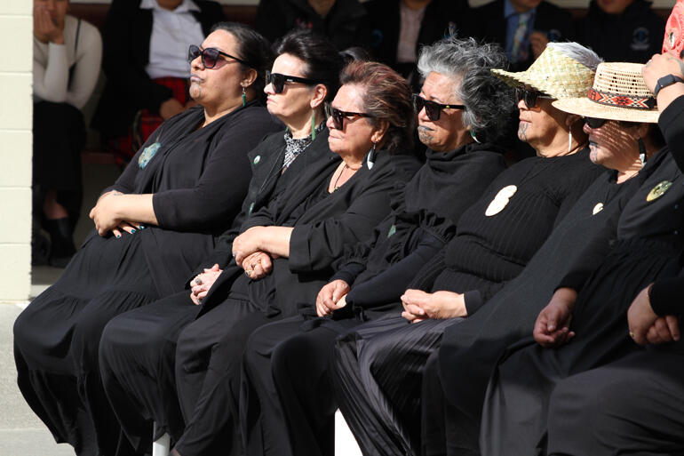 Wāhine listen to speeches on the tangata whenua side. Wāhine listen to speeches on the tangata whenua side.
