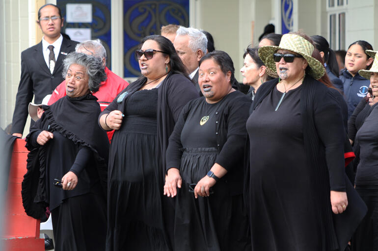 Wahine toa back their speaker at the pōhiri in Ōmahu. Wahine toa back their speaker at the pōhiri in Ōmahu.
