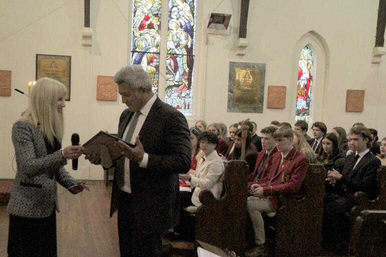 Te Maru Pūmanawa- Selwyn Board Chair Anne Stevens QC presents Bishop Muru Walters' life fellow award to his son John Walters.