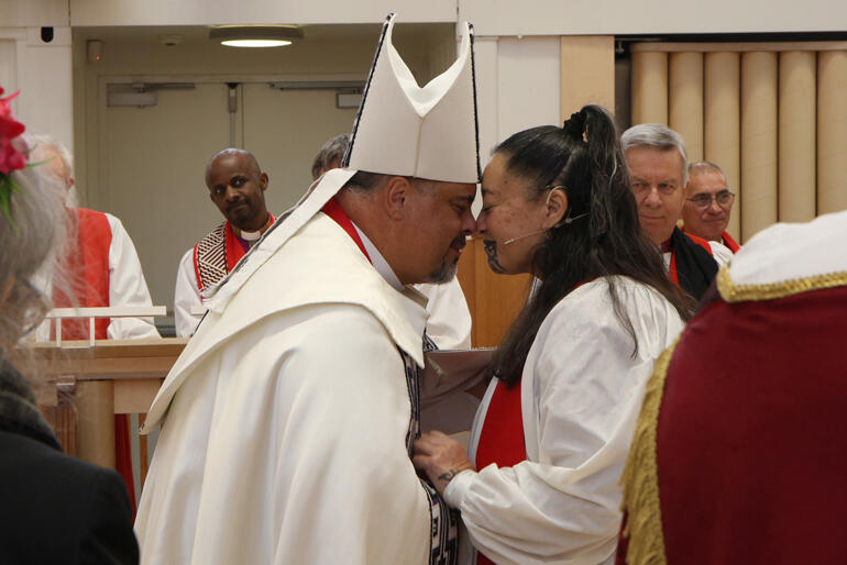 Pīhopa o Aotearoa Archbishop Don Tamihere greets Bishop-elect Susan with a hongi.