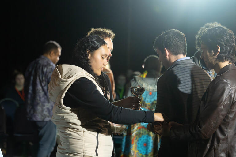 Losana Fonua distributes communion during an Abbey weekend Eucharist. Losana Fonua distributes communion during an Abbey weekend Eucharist.