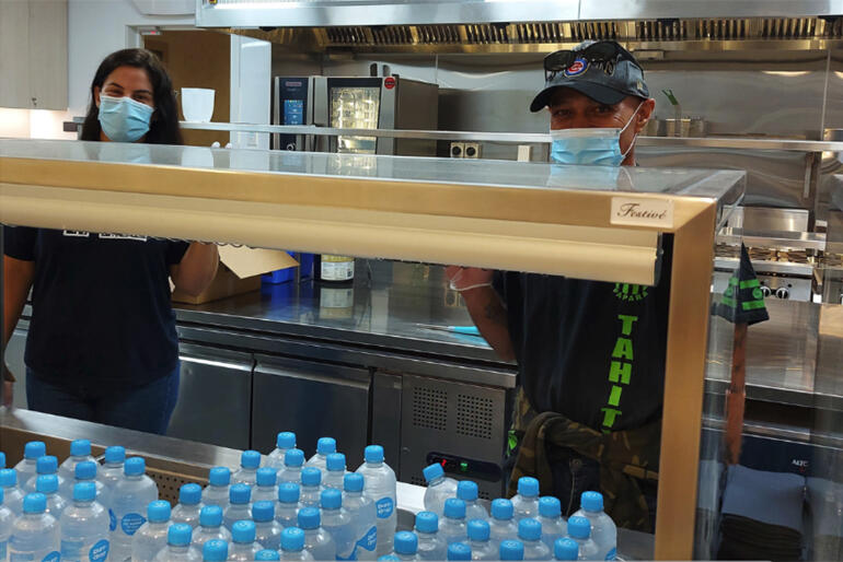 Smiles all round from staff behind the purpose-built servery counter at Te Tāpui Atawhai - Auckland City Mission's new HomeGround building.