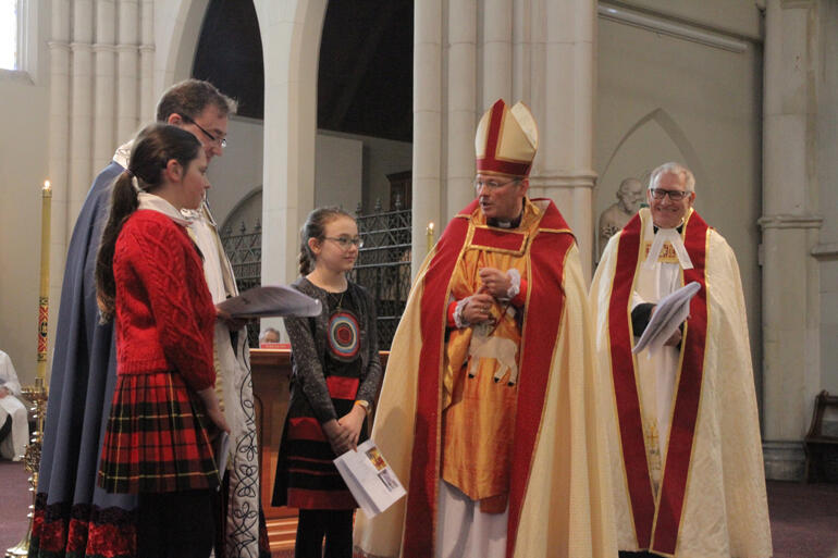 Bishop Steven Benford welcomes Ziva Curtis for her confirmation.