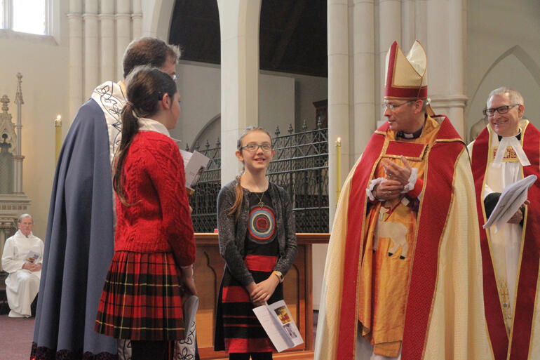 Two highs in the week after St Paul's Cathedral fire: Bishop Steven welcomes Ziva Curtis for her confirmation in St Joseph's Cathedral, Dunedin.
