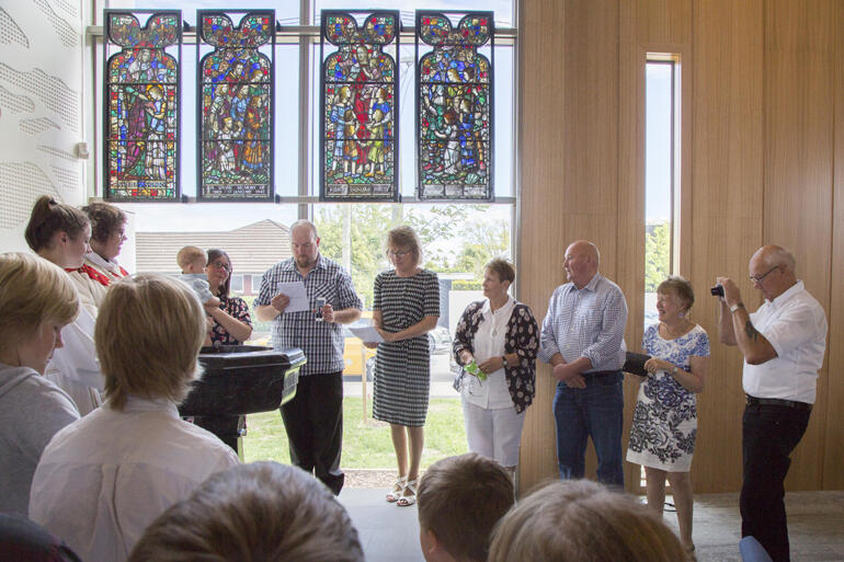 Merivale St Albans vicar, the Rev Megan Herles Mooar celebrates the baptism of All Souls' newest member in the community's long-awaited new buildings.