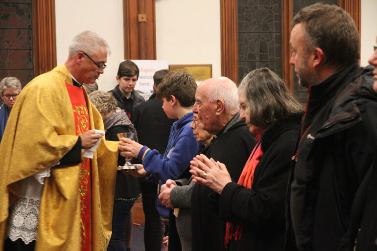 Hui members recieve the Eucharist from Fr Stephen King at St Peter's on Willis.