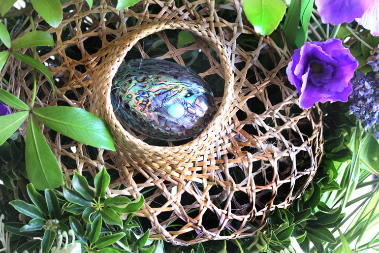 Woven harakeke and sea shells add a reusable element to wreathes and floral displays that helps set Advent in the South Pacific. 