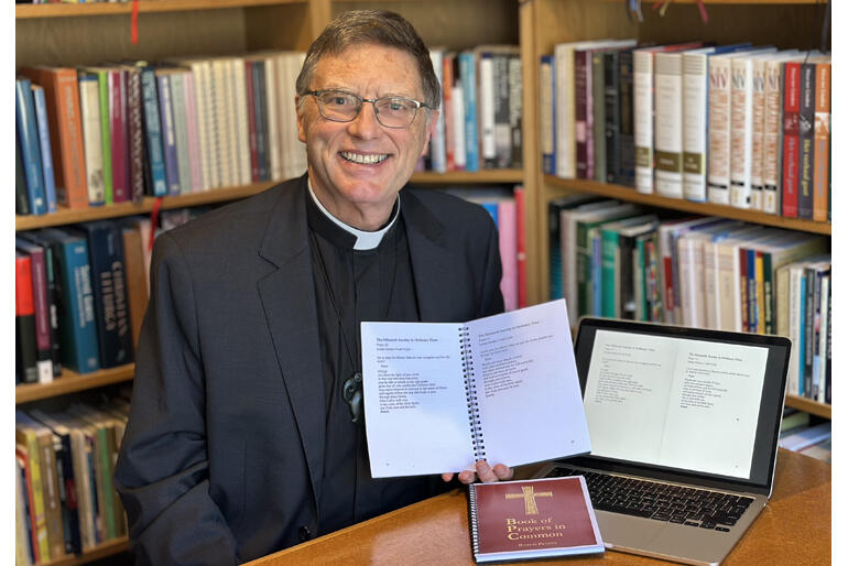 The Reverend Bosco Peters shows the digital and print copies of his collection of collects: 'Book of Common Prayers'.