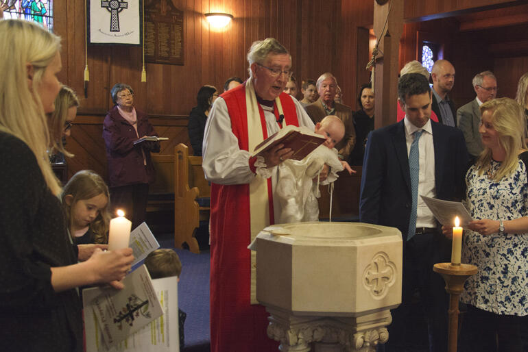 Continuing to serve long into retirement, here Bishop Peter Atkins baptises a new member of Christ's family at St Aidan's.