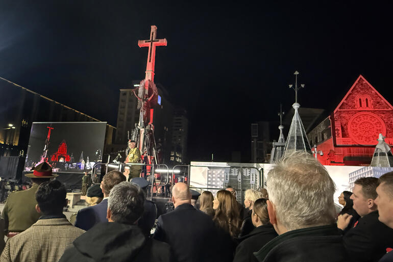 Thousands of people crowded into Cathedral Square for the 2026 Anzac Day dawn service as the Cathedral & war memorial shone poppy red.