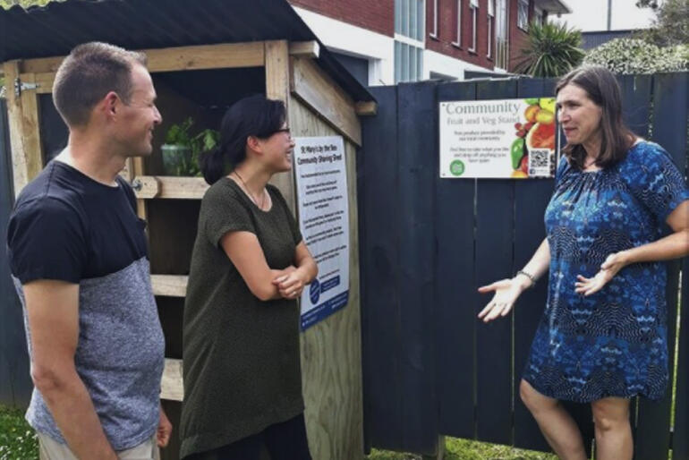 Louise Allnutt of S.Mary's Anglican Church Torbay explains their fruit and veg Sharing Shed project, as Rev Dion Blundell and Cathy Bi-Riley look on.