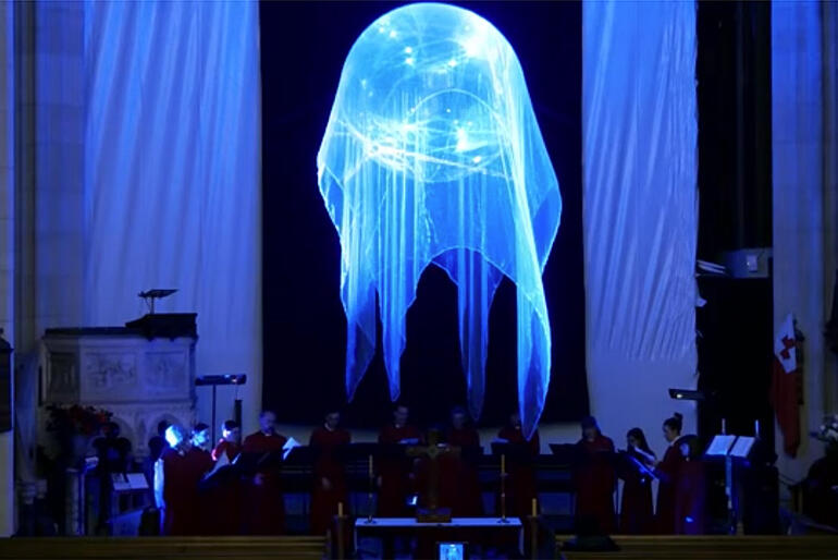 Members of St Paul's Cathedral choir sing Ēriks Ešenvalds’ “Stars” while illuminated by the installation.