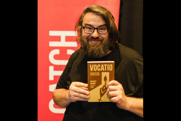Rev Spanky Moore clutches his recently published book on "Vocatio" a monastic community made up of jaded 20s-30s on a new discipleship journey.