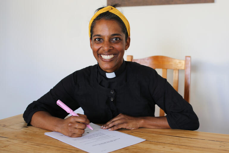 Bishop-elect Anashuya Fletcher signs her declarations as Assistant Bishop of Wellington.