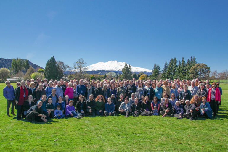 The Diocese of Wellington 2019 Synod lines up in sight of Mount Ruapehu's snow-covered slopes.