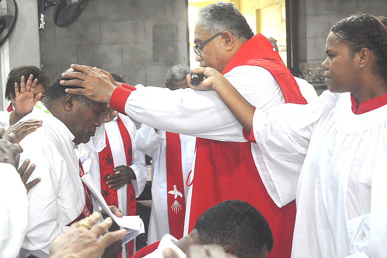 Archbishop Sione lays hands in ordination on Rev Peni Waqamaira.