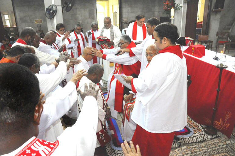 Archbishop Sione Uluilakepa blesses Rev Dan Houng Lee, one of the seven priests and six deacons he ordained in Suva on 29 July 2023.