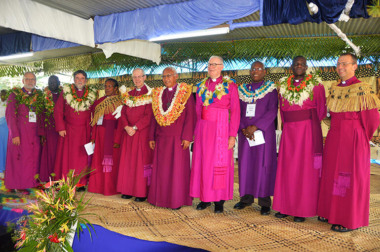 Garlanded archbishops and bishops at the cultural welcome in the grounds of Holy Trinity Cathedral.