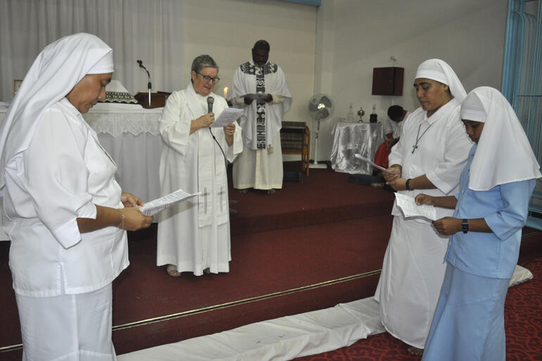 Postulant Miliva makes her vows before Moana Community of St Clare chaplain Rev Sue Halapua.