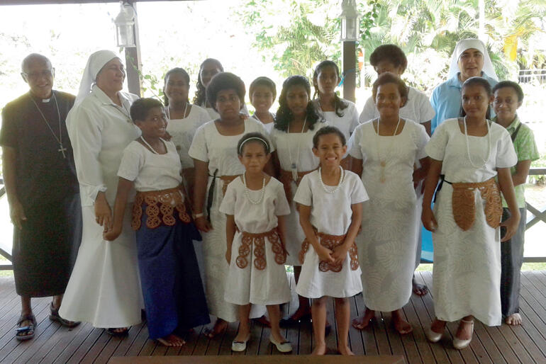 Archbishop Winston Halapua lines up with Sr Vutulongo, Sr Kalolaine and St Christopher's children in their Sunday best.