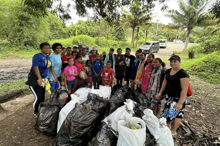 Church youth and families present their spoils from the Holy Trinity Cathedral Suva and Holy Family Waidradra beach clean-up.