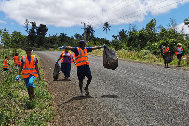 Members of Holy Cross Dreketi scour the roadsides for rubbish..