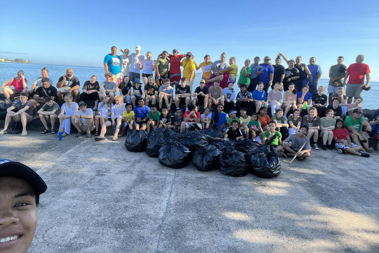 Students and staff from All Saints' Anglican School in Apia gather their bounty after a Season of Creation litter pick-up at the Apia seawall.