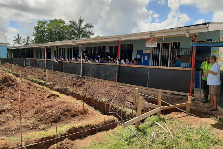 St Mary's Anglican School children look on from the sidelines as the first stage of their new classrooms take shape. 