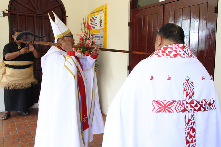 Archbishop Sione knocks on the doors at Holy Trinity, seeking entry into his Cathedral.