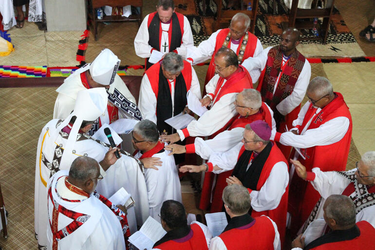 Bishops and Archbishops lay hands on Sione Uluilakepa in ordination to the episcopate.