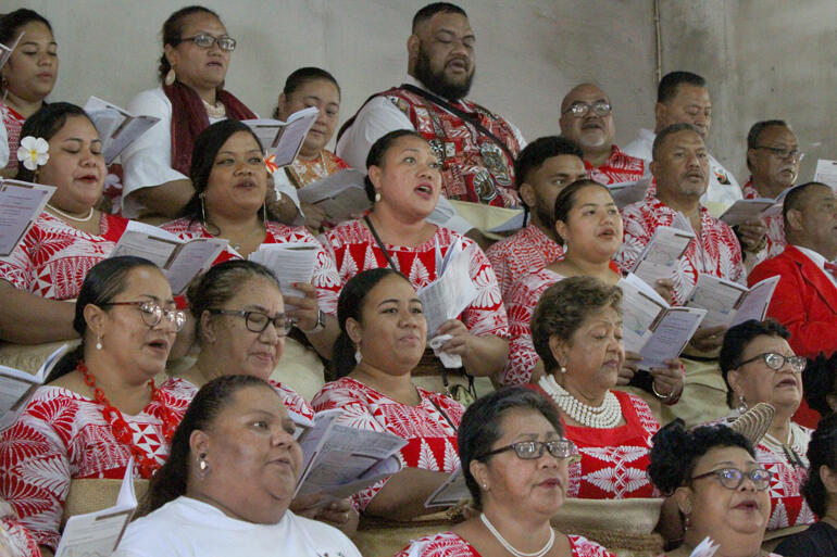 Liliani Havili (2nd to back row, 3rd from right) joins the choir singing for her boss's ordination.