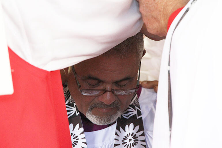 At the laying on of hands, when the gathered bishops ordain the kneeling candidate.