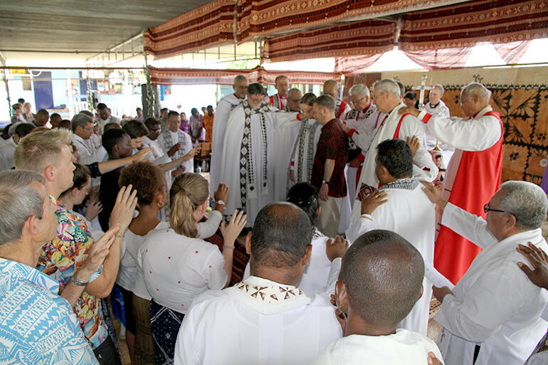 The bishops and congregation pray a blessing over the soon-to-depart Bishop Helen-Ann Hartley and her husband Myles.