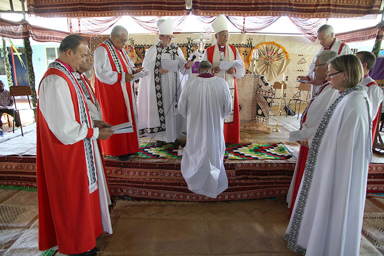 The bishops gather around Archdeacon Henry - he will arise as a bishop.