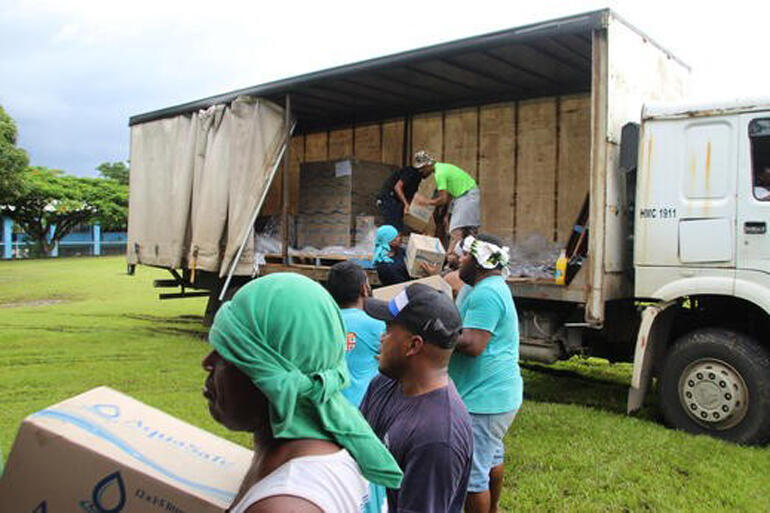 Diocese of Polynesia teams in Suva load relief items into containers for shipping to Tonga in early February. 