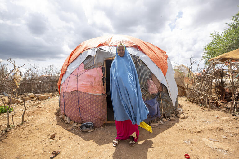 Kamila Ibrahim stands outside her makeshift home in a Baidoa IDP Camp in Somalia where she and her five children have to rely on food aid.