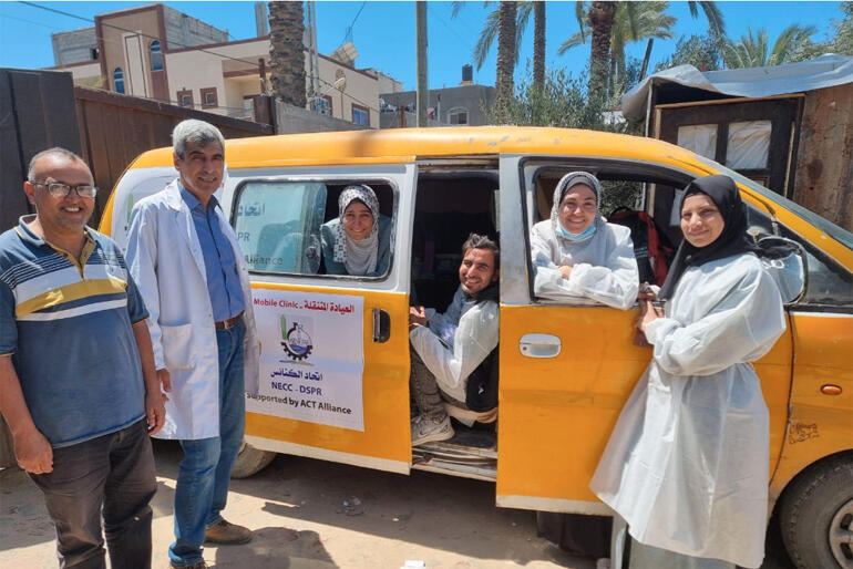 CWS partner DSPR medical staff celebrate their new mobile health clinic van, which means they can meet health needs in Gaza displacement camps.